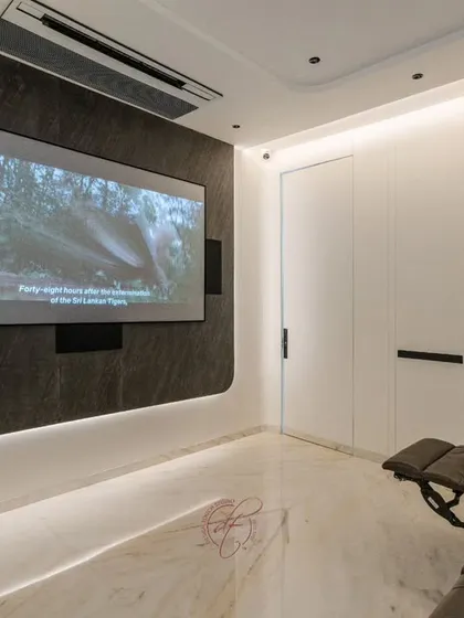 Movie night in session. This image captures the immersive experience of watching a film on the large projection screen, with the room's lighting dimmed to create a perfect theater ambiance.