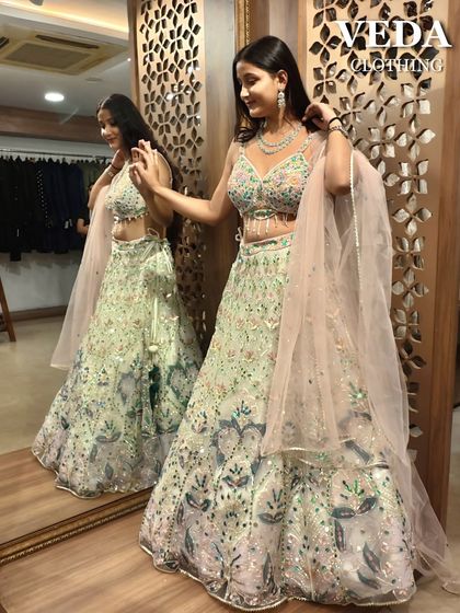 A light and airy pastel green lehenga with colorful floral embroidery. This pre-loved piece is perfect for a daytime event or mehendi ceremony.