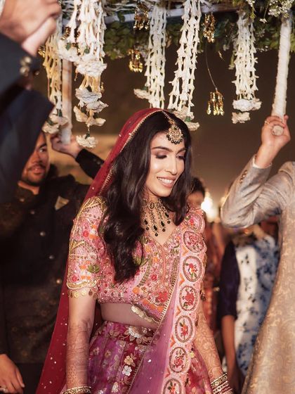 A joyful moment as Pallavi walks under the phoolon ki chaadar. Her makeup is fresh and radiant.