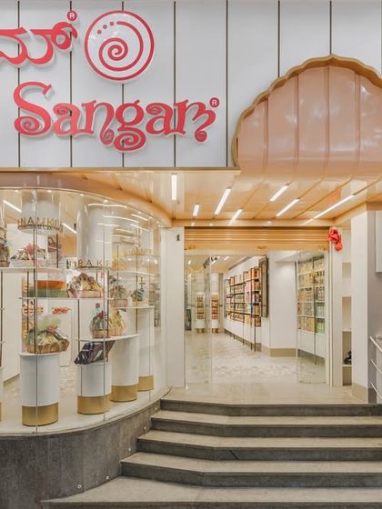 The storefront of Sangam Sweets in Kalyan Nagar, designed to reflect a craft handed down through generations. The design blends traditional motifs with contemporary flavors, creating an inviting space for a modern Indian palate.