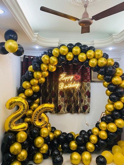 A classic black and gold theme for a 26th birthday. The full balloon ring and large foil numbers make for a bold and celebratory statement.