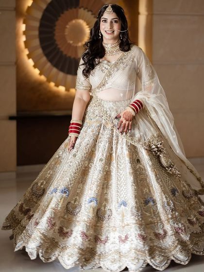 Another full-length shot showcasing the grandeur of the bridal lehenga and the complementary soft, elegant makeup.