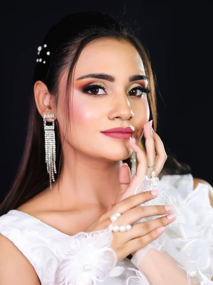 Another pose of the angelic look, highlighting the delicate hand accessories and soft makeup.