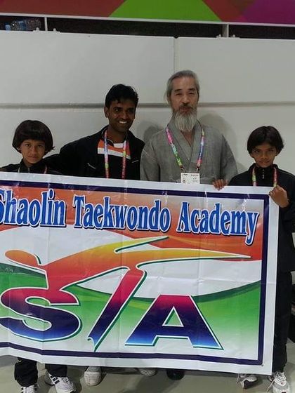 With a Taekwondo master and two young students, holding our academy banner high. We are proud to represent Shaolin Taekwondo Academy everywhere we go.