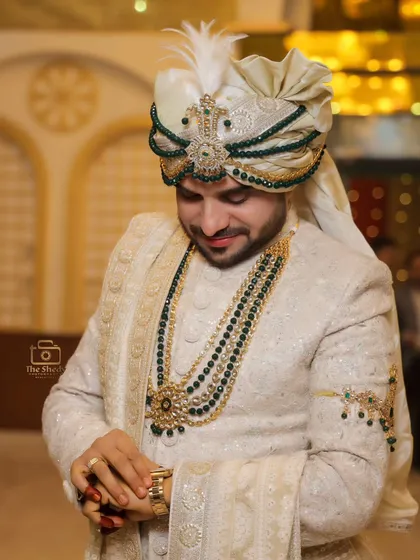 A candid moment of groom Mr. Azam, looking down with a gentle smile. This portrait captures a quiet, thoughtful moment amidst the wedding chaos.