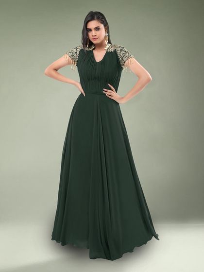 This simple yet elegant dark green gown features beautiful embellished sleeves. It's a sophisticated choice for a formal dinner or event.