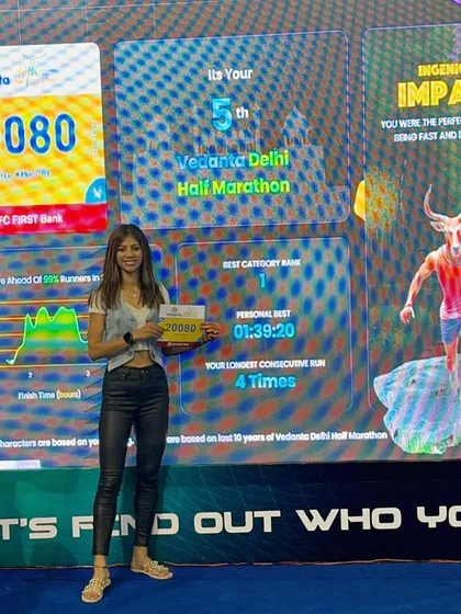 At the Vedanta Delhi Half Marathon expo, seeing my stats on the big screen. A personal best and a number one category rank from a previous year, fueling the fire for the next race.