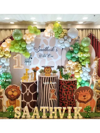 For this "Wild One" first birthday, I transformed the space into a vibrant jungle. The setup includes custom animal print pedestals, character cutouts of lions and zebras, and a lush balloon arch to create a fun safari adventure.