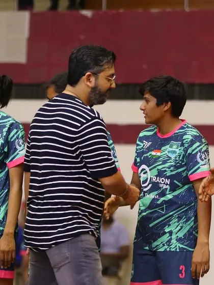 Our management interacting with players and officials at a futsal event, demonstrating our commitment to supporting football at all levels.