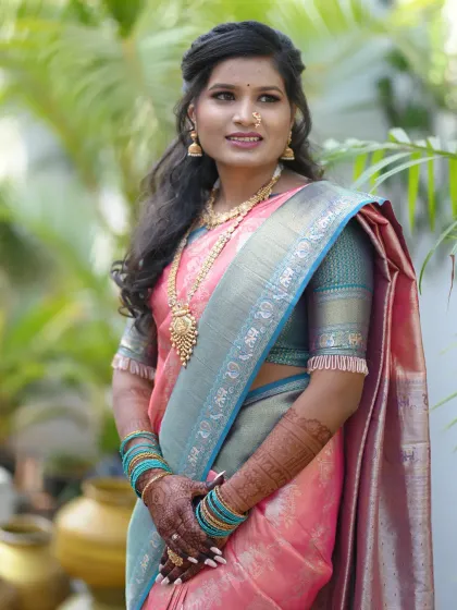 An elegant bride ready for her engagement ceremony. Her soft pink and blue saree is perfectly matched with the detailed mehendi on her hands and arms.