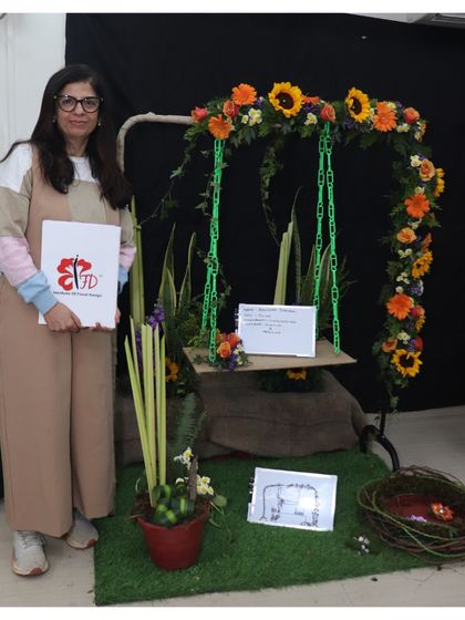 This graduating student designed a beautiful floral swing as her final piece. The arrangement on the swing and the accompanying potted design show her ability to work with different forms and concepts.