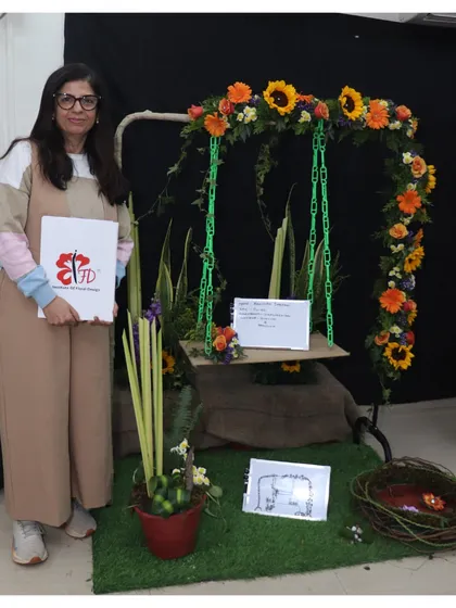 This graduating student designed a beautiful floral swing as her final piece. The arrangement on the swing and the accompanying potted design show her ability to work with different forms and concepts.