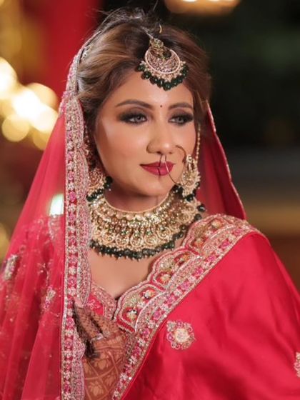 A vision of grace in red. This look features a classic brown smokey eye, a technique that beautifully defines the eyes and pairs perfectly with a traditional red lehenga.