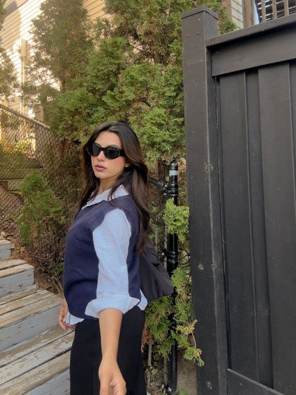 A casual street style shot, looking back at the camera.