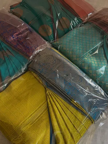 A collection of beautiful silk sarees, all neatly box-folded and packed for a customer. This method keeps them compact, organized, and completely free of creases in the wardrobe.