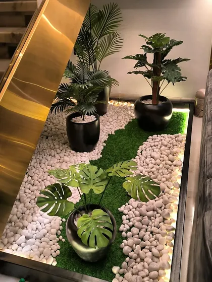 Bring the garden inside your home. I created this beautiful indoor plant corner using a strip of artificial grass, white pebbles, and some nice planters. It's a zero-maintenance way to add a touch of nature to your interiors.