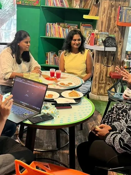 A candid moment of conversation and connection between moms at our café during a play date event.