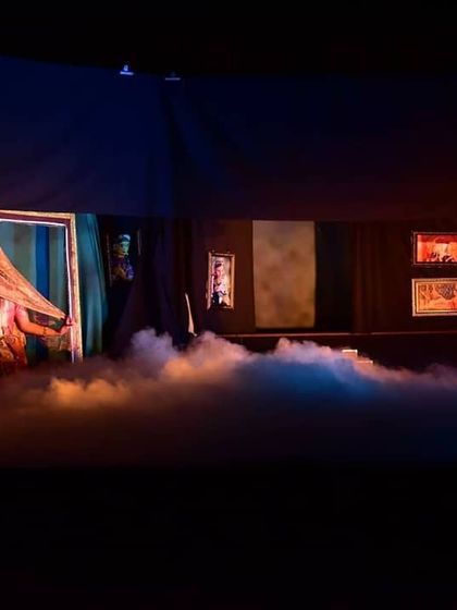 We use special effects like theatrical fog to create an ethereal and dramatic atmosphere. This scene shows a veiled puppet, adding a layer of mystery and beauty to the production.