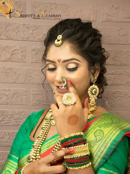A smiling shot of the model in her full Maharashtrian bridal attire, showing the beautiful result of the makeup and hairstyling demonstration.