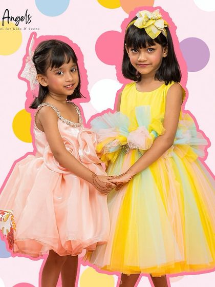 Two friends, one in our peach "Flower Dress" and the other in the yellow "Pretty Ivy" dress.