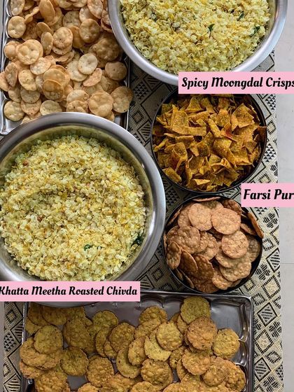A spread of my popular dry snacks. This includes Khatta Meetha Roasted Chivda, Spicy Moongdal Crisps, and Farsi Puri, offering a range of textures and flavors.