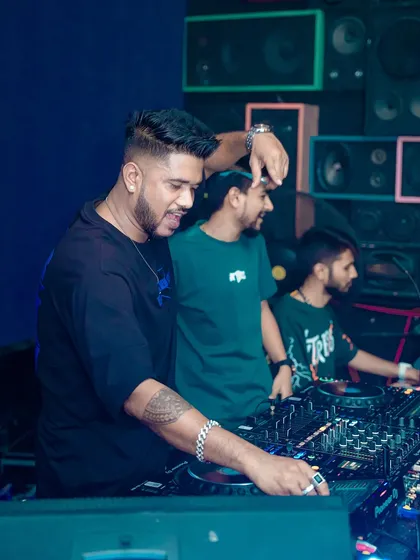 Sharing a laugh with my team behind the decks. It's a team effort to create these unforgettable nights.