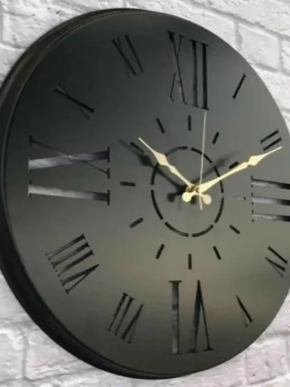 A solid, bold design, this wooden analogue clock features cutout Roman numerals against a solid black face. The antique finish and classic styling make it a substantial and stylish piece for any wall.