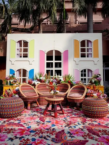 A fun photo-op corner designed to look like a colourful French villa, complete with window shutters and floral arrangements.