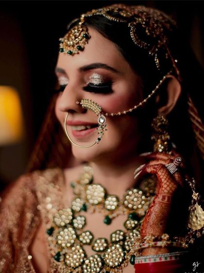 A close-up of bride Tanvi's sparkling eyes and her intricate nath.