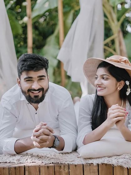 A relaxed and happy portrait from the picnic shoot. The couple lies down, sharing a smile, creating a casual and intimate photo.