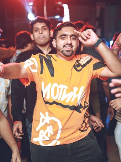 A partygoer with hands in the air, feeling the music. It's this energy exchange with the crowd that makes being a DJ so rewarding.