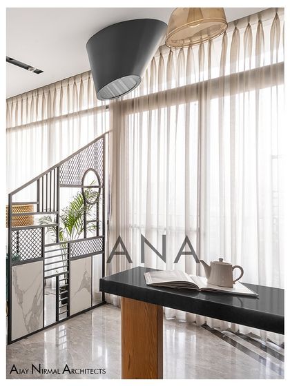 A detail of the custom metal partition and bar table in Apartment 704. This element acts as a visual separator while maintaining the open feel of the living area.