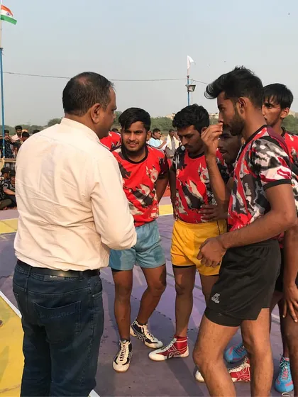 One of our senior mentors giving valuable advice to the team during a break in a tournament.