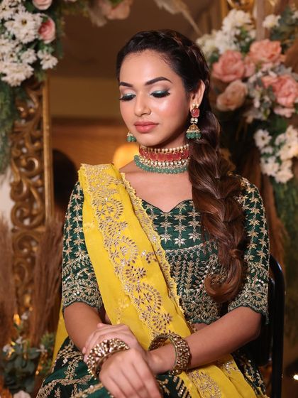 The combination of the green and yellow outfit with the green eye makeup is simply perfect. This look is a great inspiration for a mehendi or haldi function.