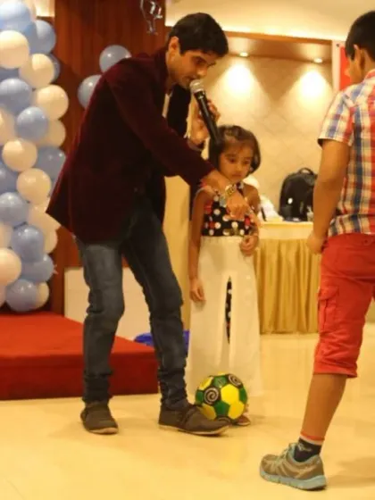 Making sure even the youngest guests feel like the star of the show. Here I am at a birthday party, engaging with a little one during a fun activity. Creating a comfortable and fun atmosphere for kids is a key part of my hosting style.