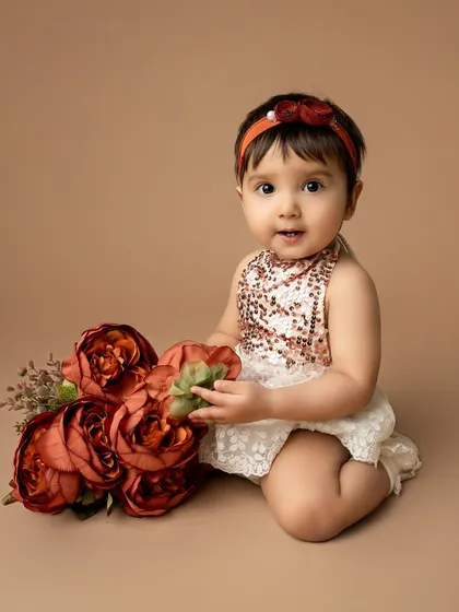 A quiet moment with the flowers. Even during a lively first birthday shoot, there are opportunities for sweet, gentle portraits like this one.
