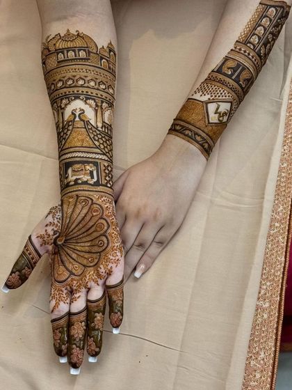 A side view of the peacock and floral bridal mehandi, showing the intricate details and the beautiful contrast between the two hands.