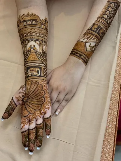 A full view of the peacock fan design, showing how it extends into a full arm piece with architectural details.