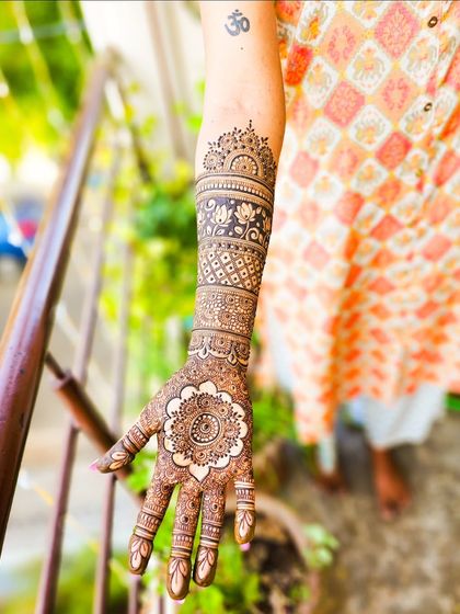 A single arm shot showing the full design, including a small Om tattoo, which I can easily work around.