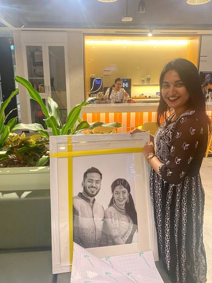 A happy client receiving her commissioned couple portrait. It's always a joy to deliver the finished artwork in person.