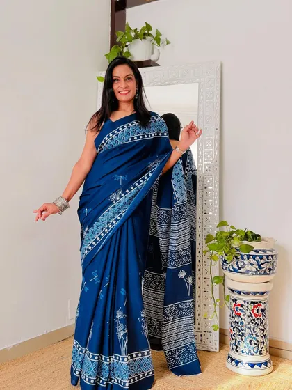 An indigo blue cotton Mulmul saree with a beautiful nature-inspired print. This is a classic and elegant choice for everyday wear.