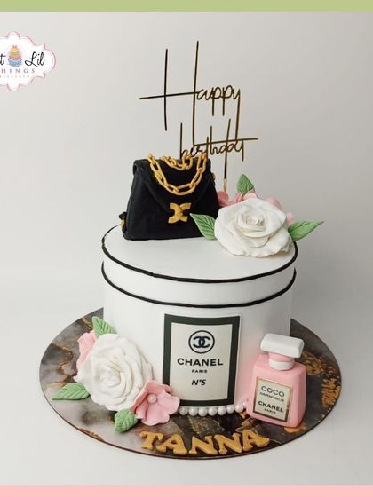 A luxurious Chanel-themed cake for Tanna. This design is shaped like a classic Chanel box and is topped with an edible handbag and perfume bottle.
