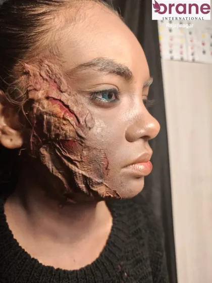 A side profile of a highly realistic SFX burn effect, created using techniques taught in our media makeup course.