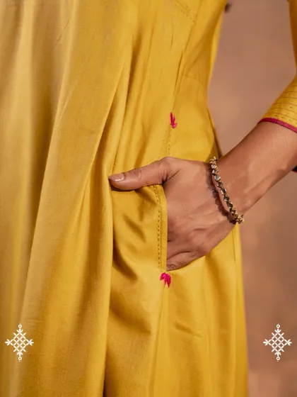 We believe clothes should be as practical as they are beautiful. This close-up shows the discreet side pocket on our Ruhani Yellow Pleated Kurta, a small detail designed for the needs of real women.