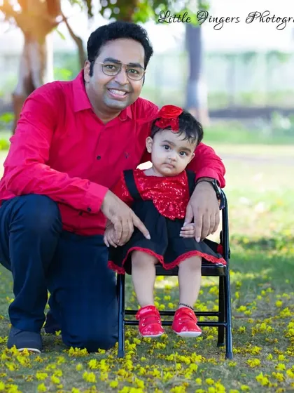 A father and daughter portrait, celebrating her first birthday in matching colors.
