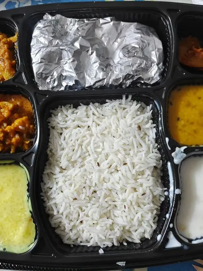 Here is a real look at one of my premium thalis. This one had Dal, Aloo Gobhi, soft Rotis, Rice, Kheer, Salad, Pickle, and Raita. A complete, wholesome meal that fills your stomach and your heart.