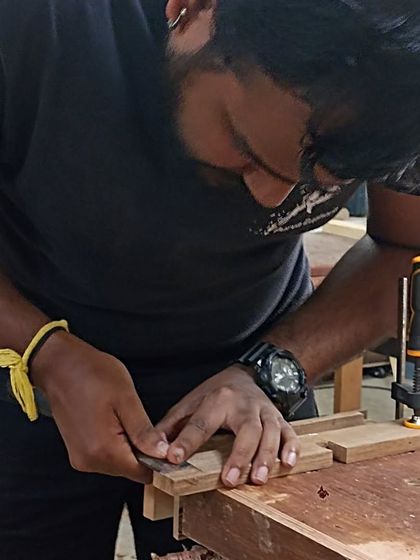 Tejus using a marking gauge to scribe a line for a tenon. Accurate marking is the first step to accurate joinery.