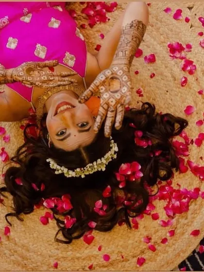 Weddings are incomplete without mehendi. A creative and beautiful shot of my bride Vrinda, lying amidst rose petals and showcasing her henna.