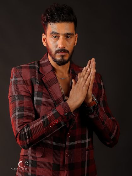 A gesture of prayer or contemplation, adding a layer of depth and meaning to the portrait. It’s a moment of quiet introspection.