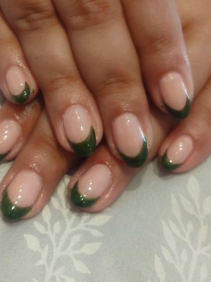 For a more understated color, I created this French manicure with deep olive green tips. It's a unique and earthy alternative to the traditional white or bright colors.